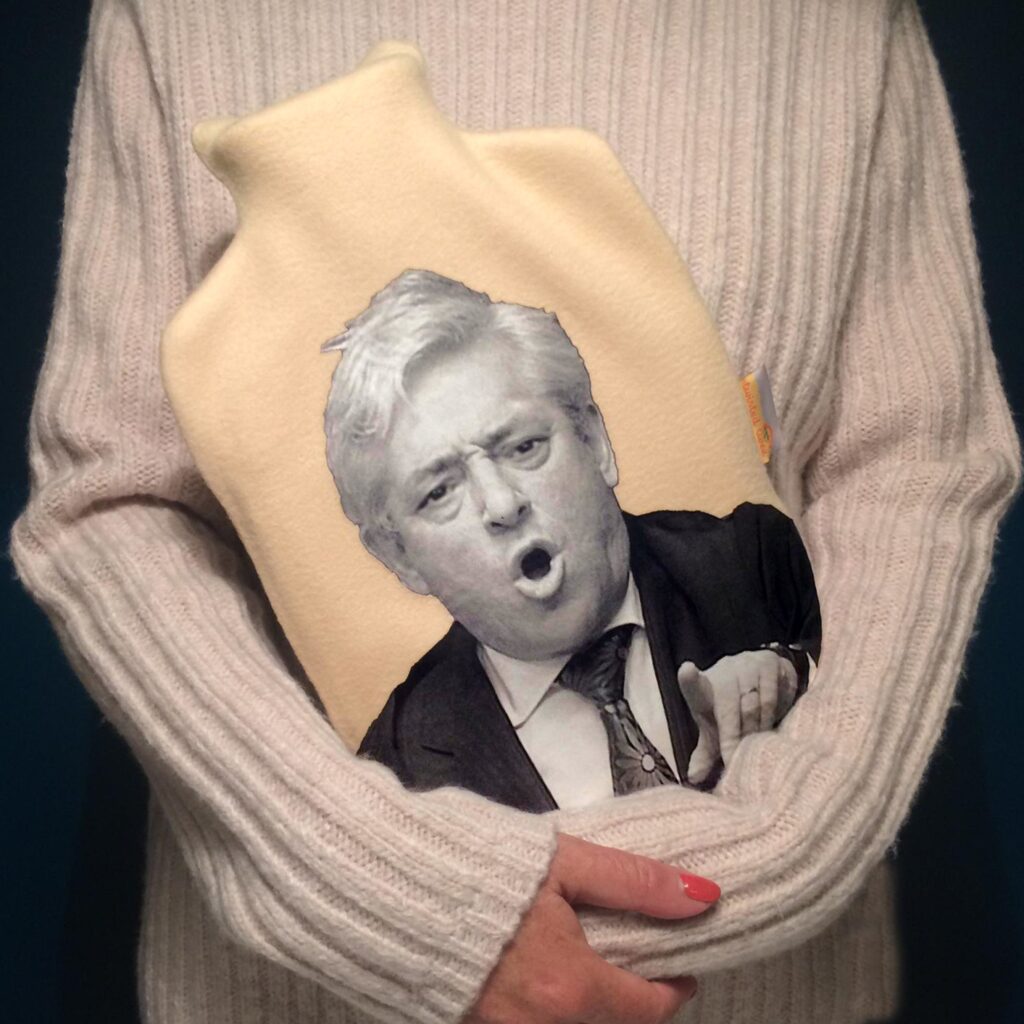 John Bercow fleece hot water bottle held by someone in a cream jumper